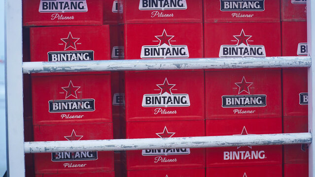 Bintang Pilsner beer boxes stacked inside a delivery truck at a loading dock during the morning hours for distribution