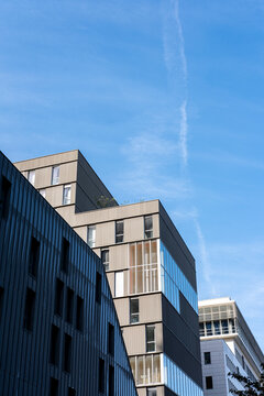 Blue sky sharpens the Paris Rive Gauche apartment facade, where modern residential architecture gives urban housing a crisp geometric edge