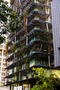 Balconies and plants deepen a Paris Rive Gauche apartment facade, turning modern residential architecture into dense urban housing texture