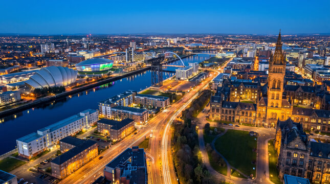 Panoramic aerial view of Glasgow city skyline at dusk with the River Clyde flowing through the urban landscape.