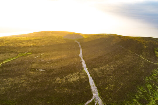 Aerial view of Queen Maeve Cairn on Knocknarea above the coast in County Sligo, Ireland. A prehistoric summit monument set in a dramatic Irish landscape.