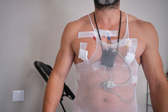 Athletic man with a Holter monitor for heart examination