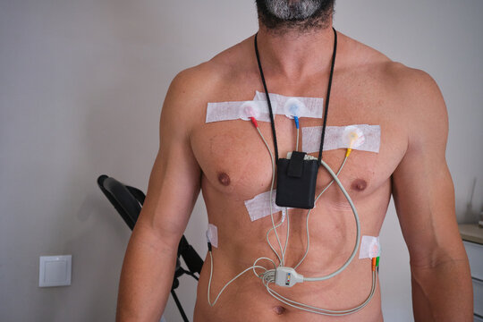 Athletic man with a Holter monitor for heart examination