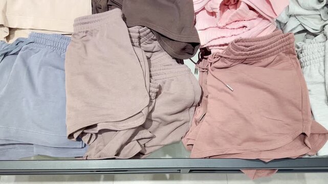 Clothes store in shopping mall.Blurred store aisle with hanging clothing racks