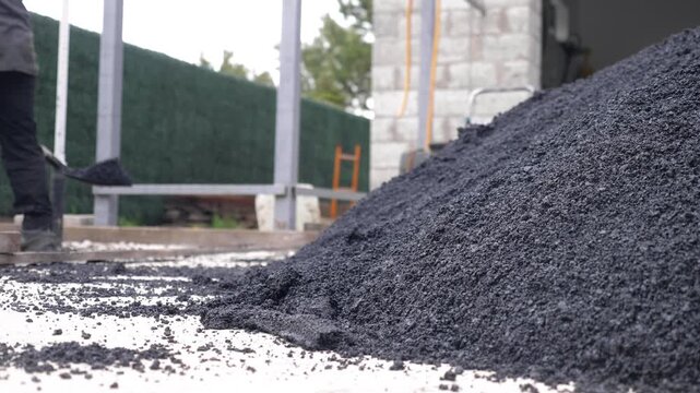 Workers Shoveling Fresh Asphalt for Small Area Road Paving