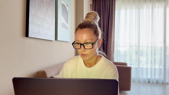 a young woman working on a laptop from home