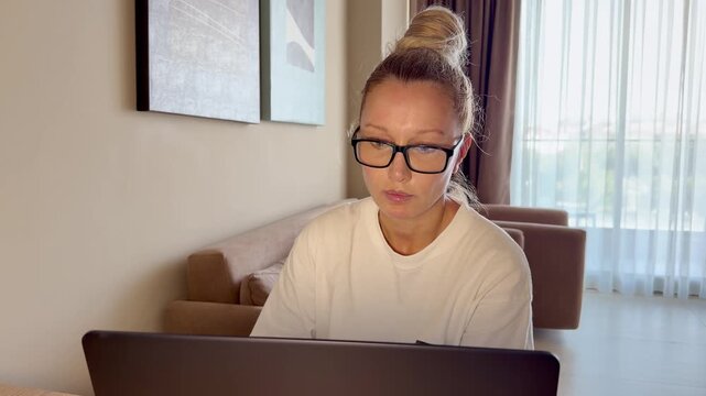 a young woman working on a laptop from home