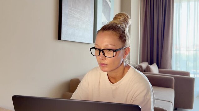 a young woman working on a laptop from home