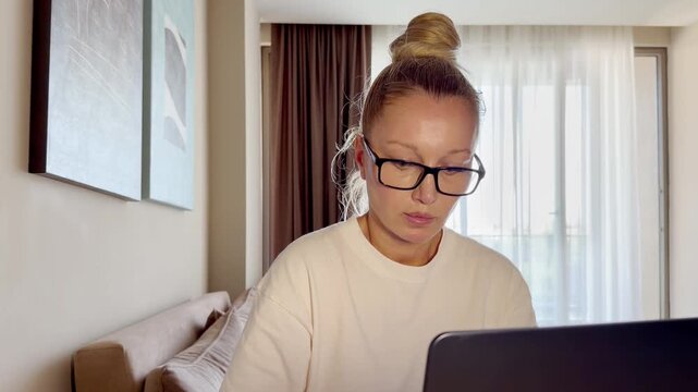 a young woman working on a laptop from home