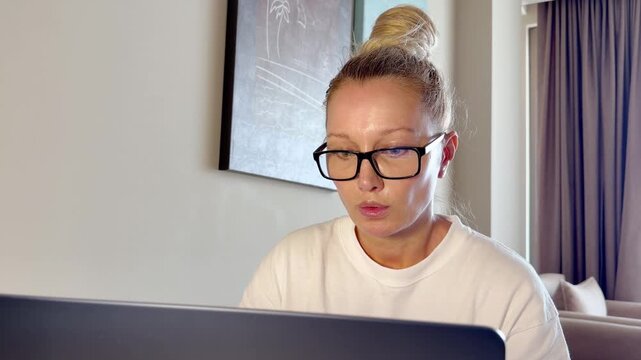 a young woman working on a laptop from home