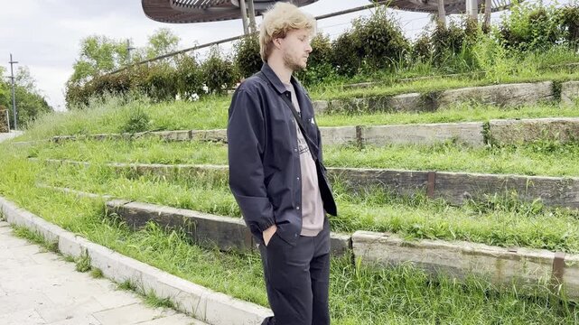 Lifestyle portrait of young man  using a smartphone outdoors