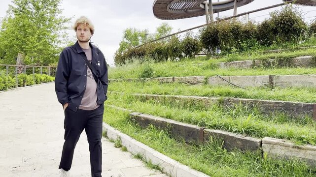 Lifestyle portrait of young man  using a smartphone outdoors