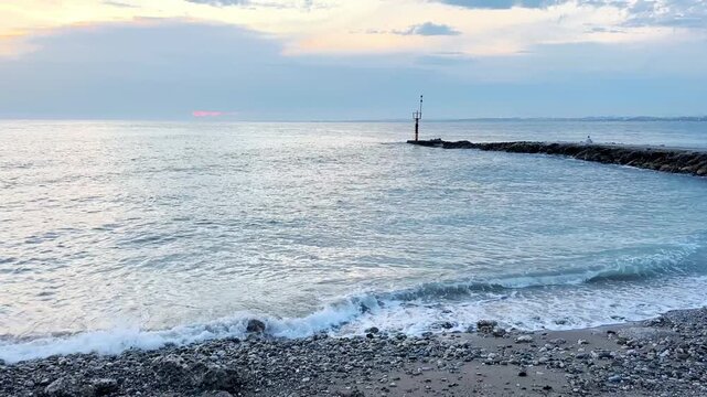 sea ​​coast at sunset, stormy waves
