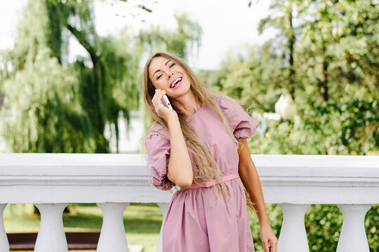 Smiling Woman Enjoying Phone Call Outdoors