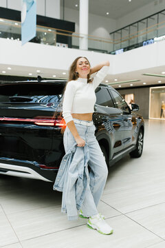 Customer Relaxing Near Luxury Vehicle in Shopping Center