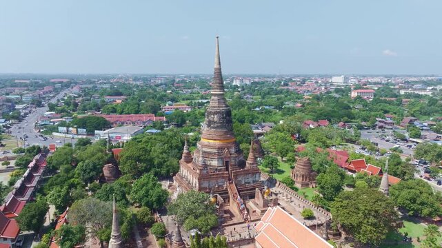 360-degree aerial view of tourists visiting the stunning ancient Wat Yai Chai Mongkhon Temple, a historic Buddhist temple in the Ayutthaya Historical Park, Thailand