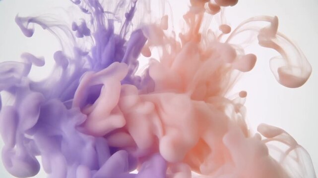 Vibrant purple and pink ink swirls merge in a mesmerizing dance of colorful liquids on a clean white background.