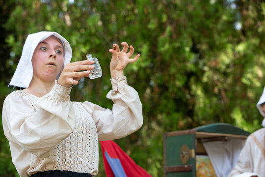Woman acting medieval reenactment holding glass vial