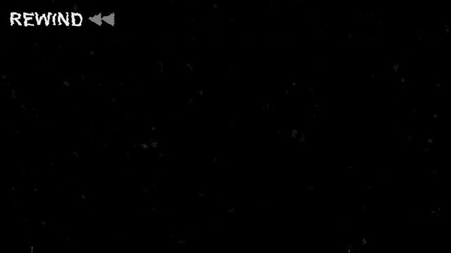 Vintage VHS tape rewind effect with analog static noise and old television screen distortion creating a retro video playback error background