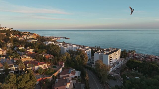 Scenic aerial sunset view at coastal Malaga residential neighborhood with El Dedo beach, Andalusia, Spain