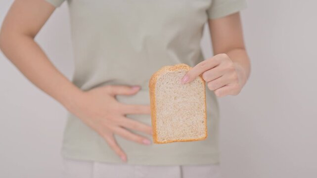 Gluten intolerance, Gluten free and celiac disease or Wheat allergy. woman with wheat bread and having abdominal pain after eat gluten. stomach ache, Nausea, Bloating, Gas, Diarrhea and Skin rash