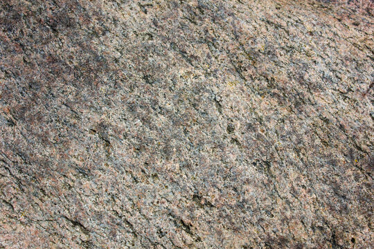 Close-up of granite. Authentic stone surface texture, natural stone, background.