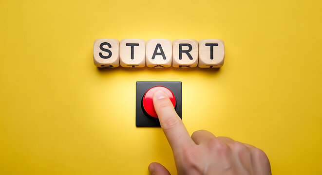 Hand pressing red button with start text on wooden blocks on yellow background