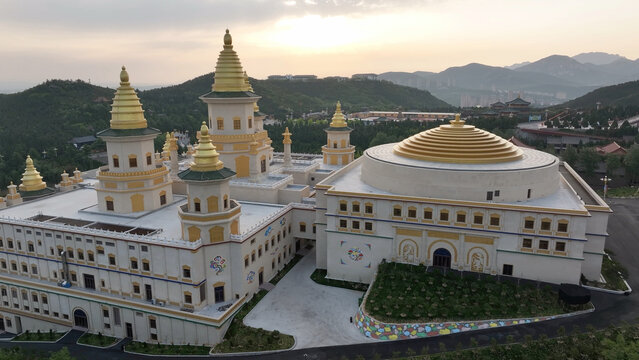 Chishan Fahua Temple complex with golden pagodas and domes in Weihai Shandong at sunset