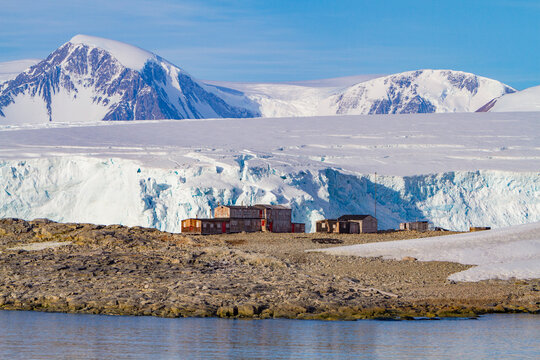 Research base on Stonington Island offers views of ice and mountains in Antarctica during a clear day