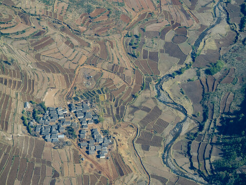 Charter flight over rural village and farmlands in Madagascar near Isalo National Airport