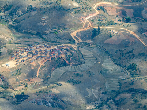 View of terraced farmland and rural settlement during charter flight in Madagascar