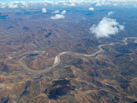 Charter flight view of a river winding through mountains in Madagascar landscape