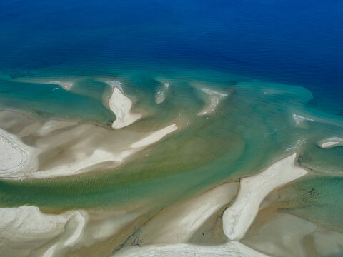 Charter flight displays river flowing into sea near Antanavarino in Madagascar, showcasing natural landscape features