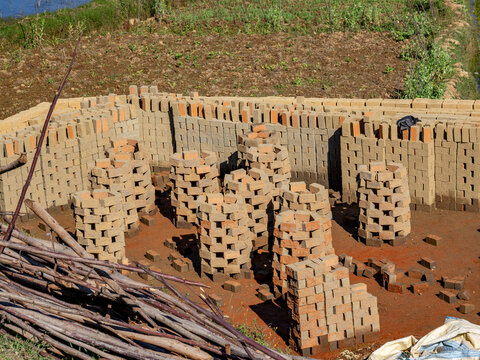 Workers create fresh bricks from mud along the highway leading to Andasibe, Madagascar during a sunny day