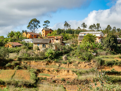 Scenes of rural life along highway N2 from Antanavarino to Andasibe in Madagascar with houses and fields