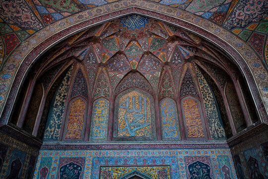 Details of intricate tile work and calligraphy inside Wazir Khan Mosque in Lahore during daylight hours