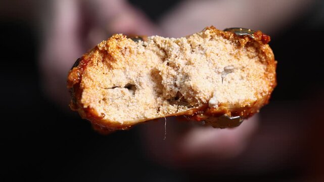 Spicy Korean fish cake being held with tongs