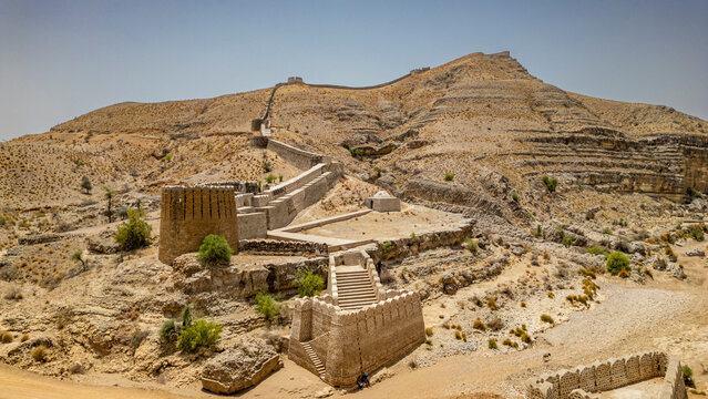 Ranikot fort stands on a rugged landscape under bright sunlight in Sindh, Pakistan, showcasing ancient architecture and historical significance