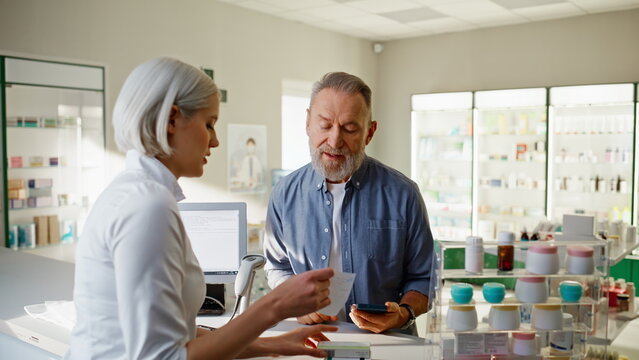 Pharmacist woman sell medicine in pharmacy cashier counter help customer closeup