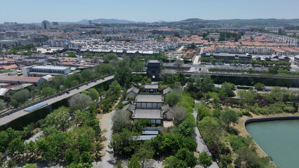 Fototapeta premium Aerial view of Qingzhou Ancient City featuring traditional architecture, gardens, and water systems