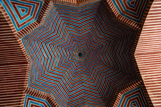 Decorative ceiling of Shah Jahan Mosque showcasing intricate geometric patterns and colors, located in Sindh, Pakistan