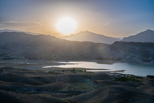 View of Naghlu lake during sunset in eastern Afghanistan with mountains in the background