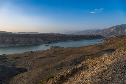 View from the overlook at Naghlu lake in eastern Afghanistan during daylight hours with mountains in the background