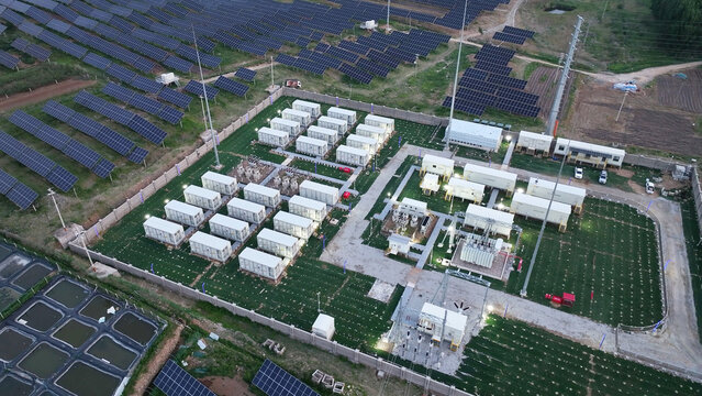 Photovoltaic power station with energy storage containers and solar panel arrays