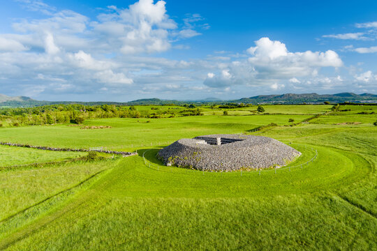 Aerial view of Carrowmore Passage Tomb surrounded by bright green fields in County Sligo, Ireland. An ancient megalithic monument in the Irish countryside.