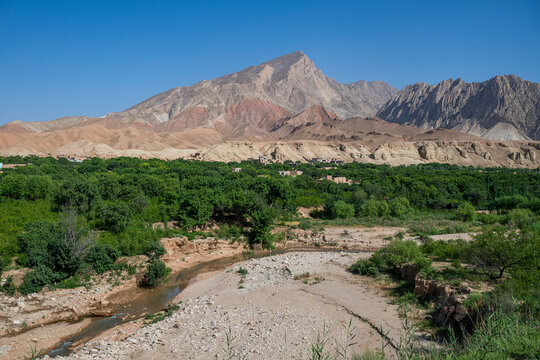 View over the landscape of Samangan in Afghanistan with mountains and river beneath clear sky