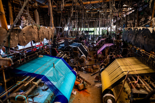 Looming activity in a factory showing looms and colorful fabrics in Bangladesh