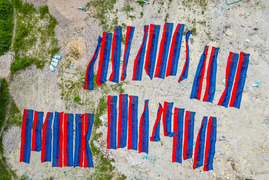 Brightly dyed cloths drying under the sun in Araihazar village during the textile dyeing process in Bangladesh