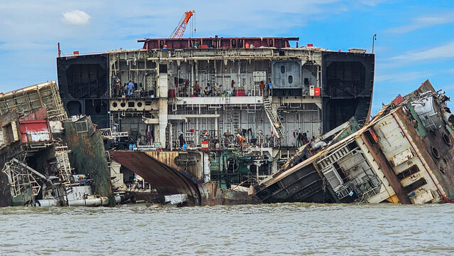Exploration of shipwreck cemetery with various ship remains in bodies of water and workers near wrecks in Bangladesh