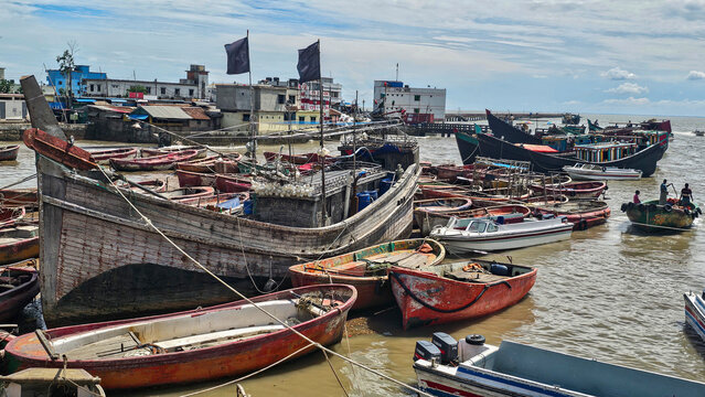 Fishing boats in a shipwreck cemetery by the shore in Chittagong, Bangladesh during daytime
